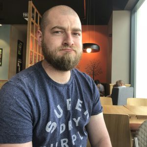 Portrait of a Frowning bearded millennial man